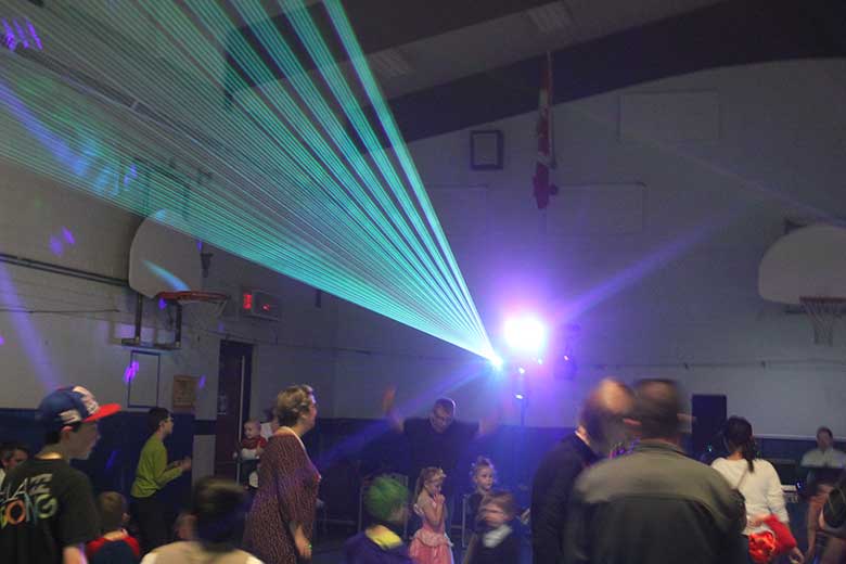School Light Show, DJ Hamilton, Family Dance Turquoise flat fan of beams coming from laser. Taken in Hamilton Ontario.